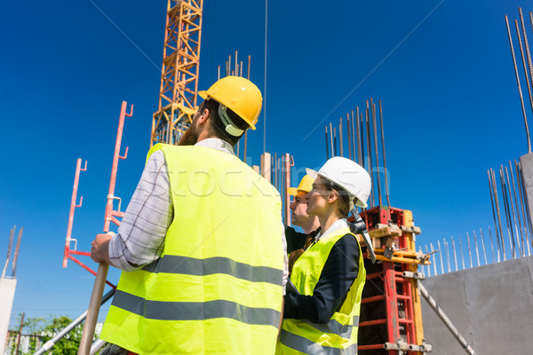 Experienced female architect or manager guiding the workers Stock photo © Kzenon