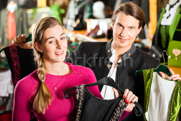 Young couple is buying Tracht or dirndl in a shop Stock photo © Kzenon