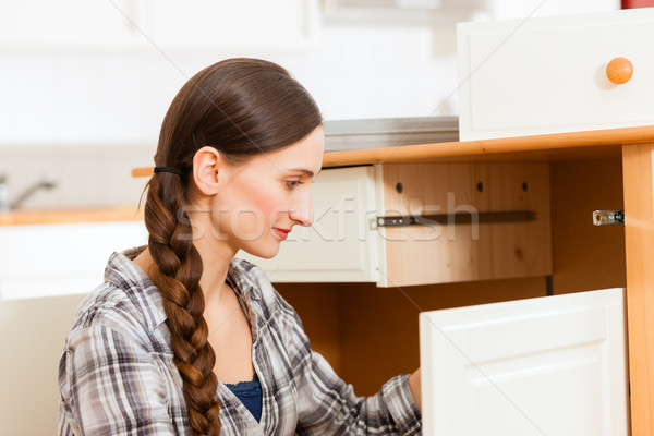 Young woman is assembling a cupboard Stock photo © Kzenon
