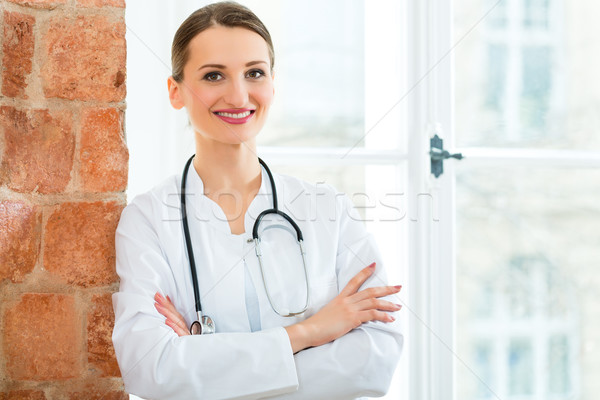 Stock photo: Portrait of young female doctor in clinic