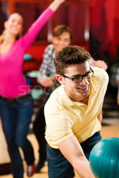 Stock photo: Friends bowling having fun