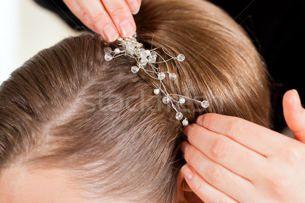 Stylist pinning up a bride's hairstyle Stock photo © Kzenon