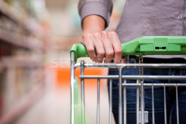Young woman with pushcart in supermarket Stock photo © Kzenon