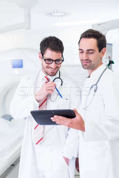 Doctors discussing images of x-ray scan in CT Stock photo © Kzenon