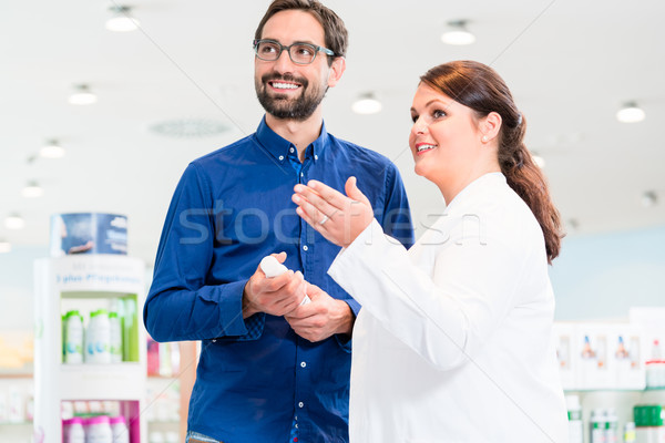 Man in drug store with sales lady shopping Stock photo © Kzenon