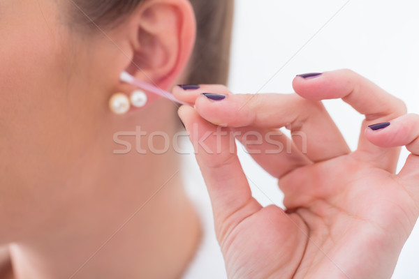 Woman cleaning her ears with cotton bud Stock photo © Kzenon