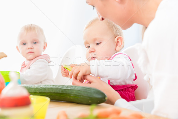 cute baby girl eating healthy solid food in a modern daycare center Stock photo © Kzenon