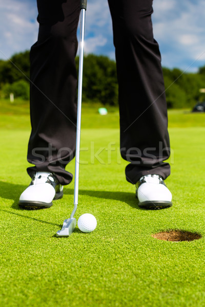 Golf player putting ball in hole Stock photo © Kzenon