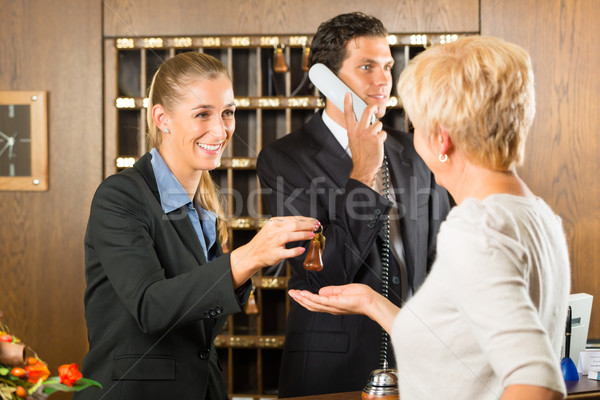 Reception - Guest checking in a hotel Stock photo © Kzenon
