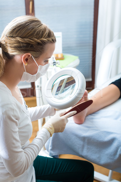 Woman in poidatry studio receiving pedicure Stock photo © Kzenon