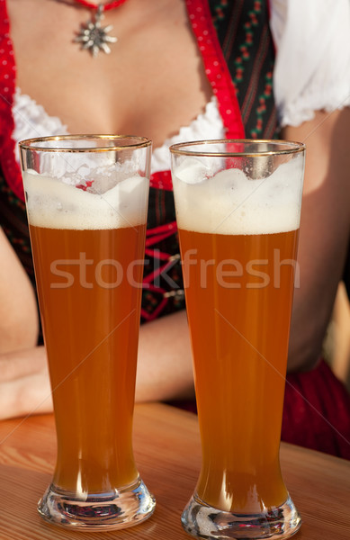 Couple in Bavarian Tracht clinking glasses  Stock photo © Kzenon