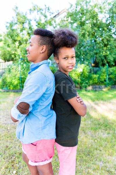 Brother and sister standing in garden Stock photo © Kzenon