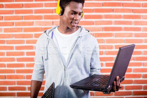 Hacker or computer programmer with laptop Stock photo © Kzenon