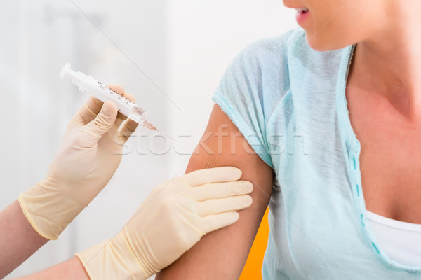 Femeie medic vaccinare seringă braţ durere Imagine de stoc © Kzenon