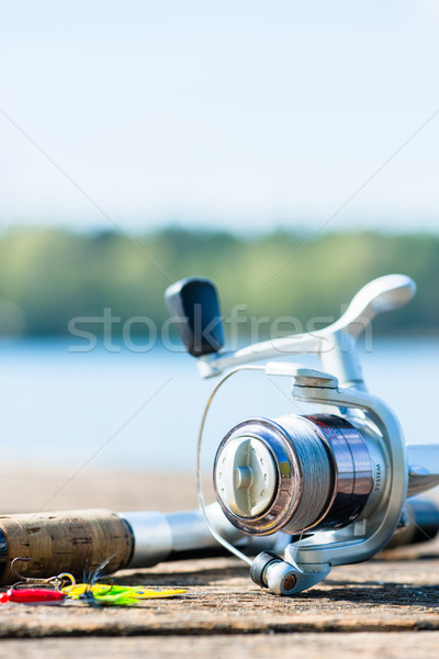 fishing rod on jetty close to lake Stock photo © Kzenon