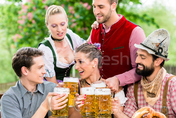 In Beer garden - friends drinking beer in Bavaria Stock photo © Kzenon