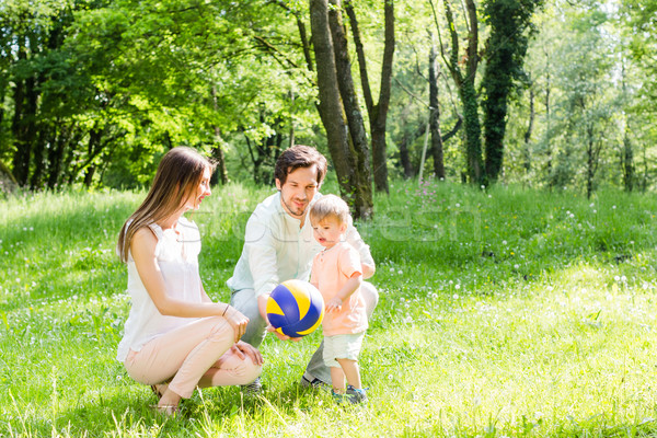 Mom, dad, and child playing with ball Stock photo © Kzenon