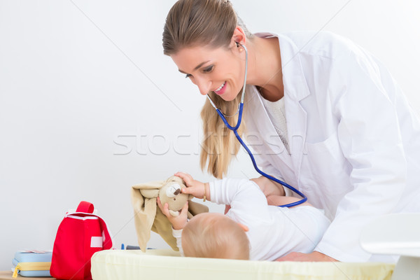 Dedicated pediatrician using the stethoscope during the check-up Stock photo © Kzenon