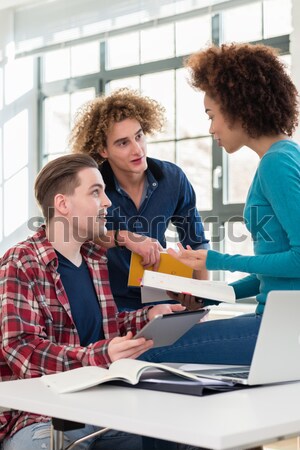 Two young students searching for an answer to their question Stock photo © Kzenon