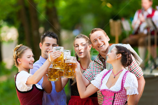 In Beer garden - friends in front of band Stock photo © Kzenon