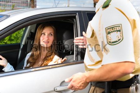 Police - woman in traffic violation getting ticket Stock photo © Kzenon