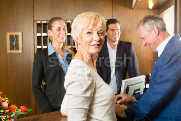 Reception - Guests check in a hotel Stock photo © Kzenon