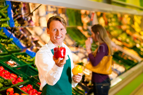Man in supermarket as shop assistant Stock photo © Kzenon