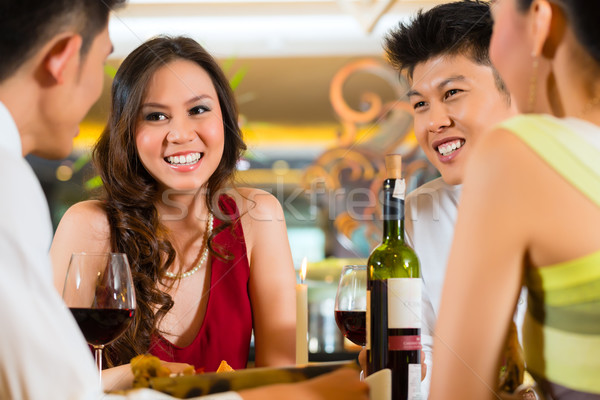 Chinese business people dining in elegant restaurant Stock photo © Kzenon