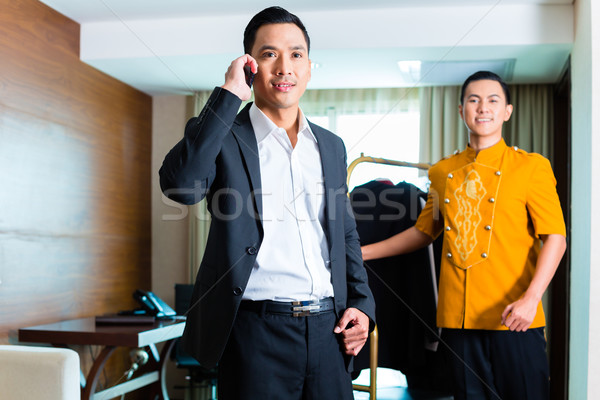 Guest and bell boy standing in hotel room Stock photo © Kzenon