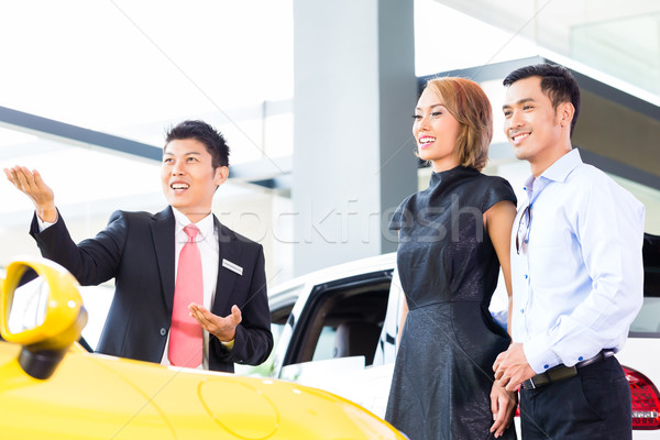 Asian couple buying car in dealership Stock photo © Kzenon