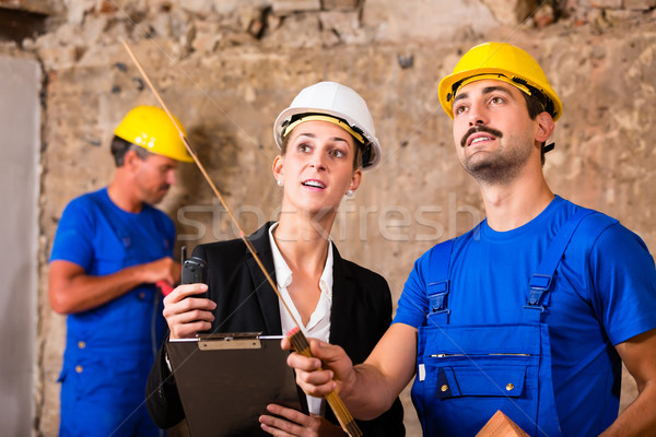 Builder and architect discussing on construction site Stock photo © Kzenon