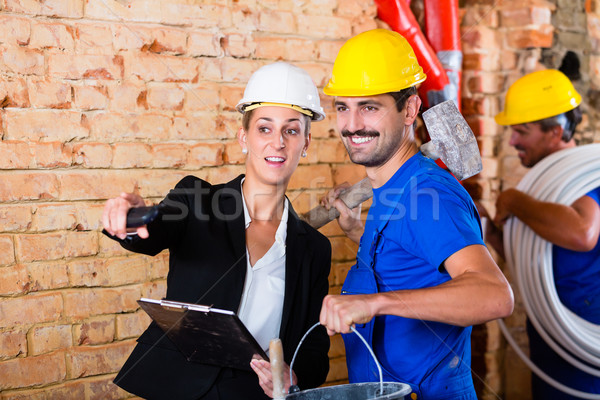 Builder and architect working on construction site Stock photo © Kzenon