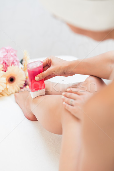 Hand of a young woman using a modern recharchable roll-on waxer  Stock photo © Kzenon