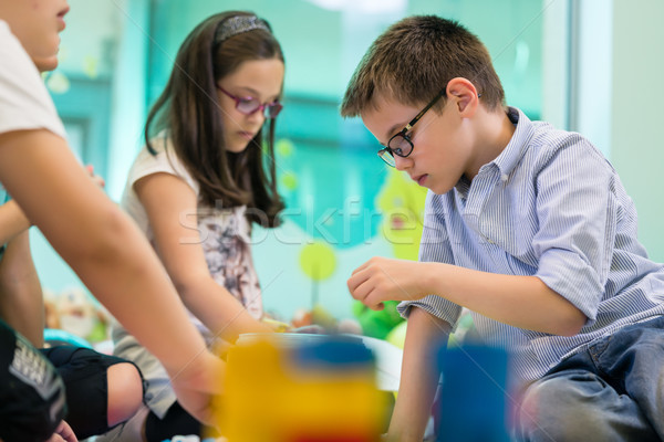 Cute girl playing next to her colleague in the classroom Stock photo © Kzenon