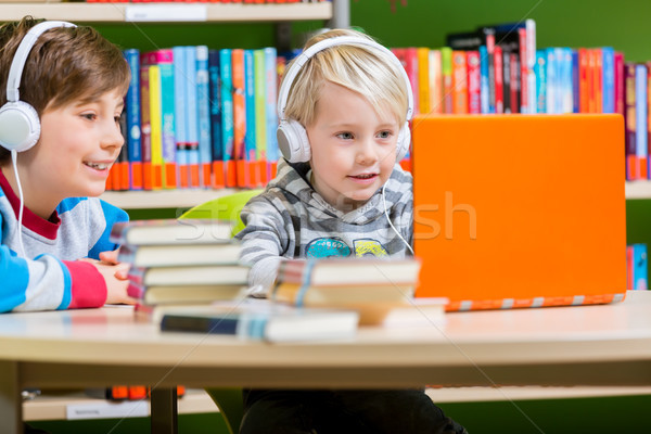 Children in a library listening to audio books Stock photo © Kzenon