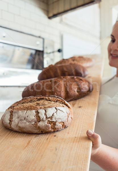 Fresh bread on a board in bakehouse of bakery Stock photo © Kzenon