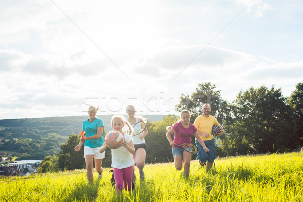 Family playing, running and doing sport in summer Stock photo © Kzenon