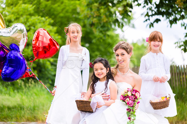 Bride with girls as bridesmaids, flowers and balloons Stock photo © Kzenon
