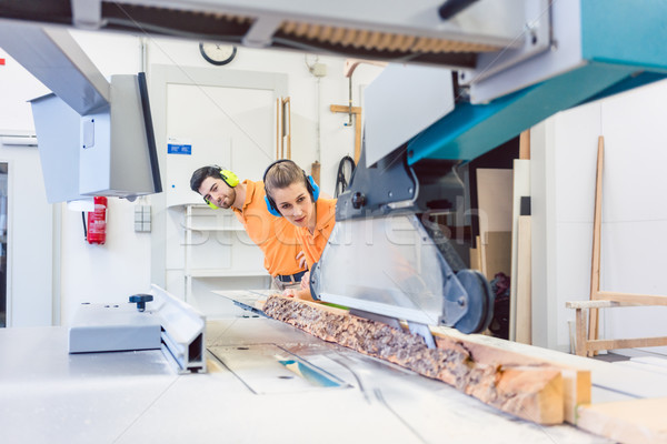 Carpenter man and woman working in workshop Stock photo © Kzenon