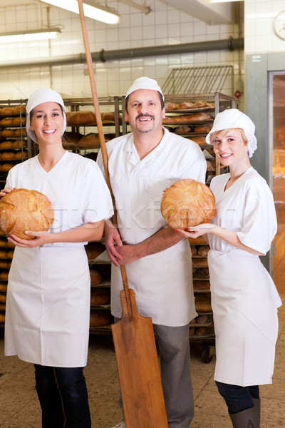 Baker with his team in bakery Stock photo © Kzenon