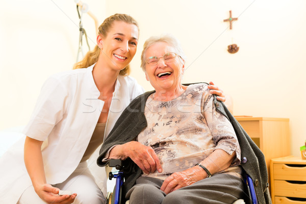 Young nurse and female senior in nursing home Stock photo © Kzenon