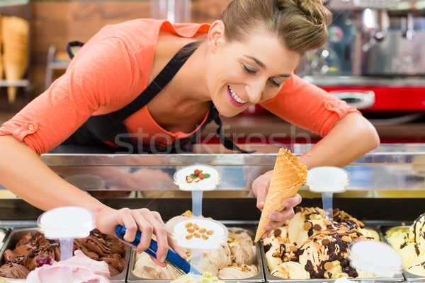 Female seller in Parlor with ice cream cone Stock photo © Kzenon