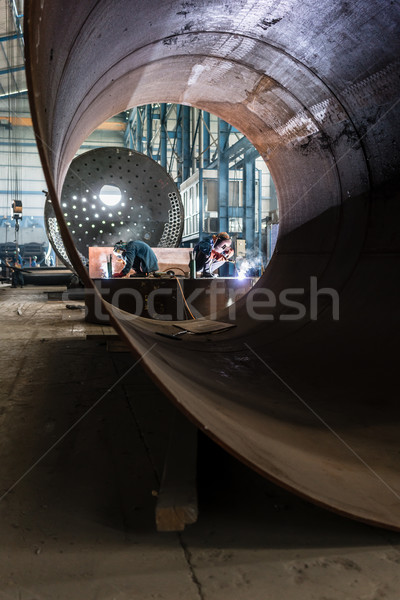 Two workers welding in a factory manufacturing boilers  Stock photo © Kzenon