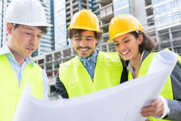 Stock photo: Architects with ground plot on construction site