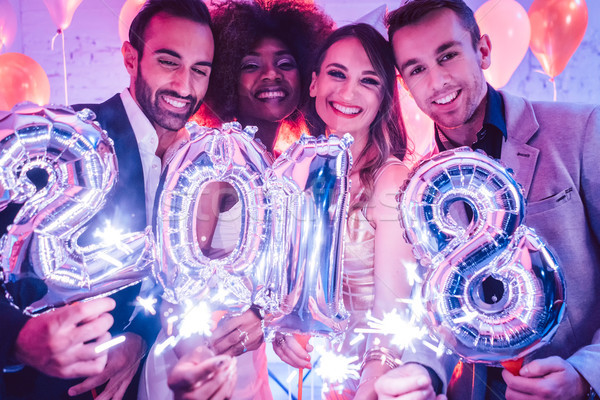 Group of party people celebrating the arrival of 2018 Stock photo © Kzenon