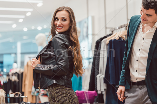 Woman trying a new leather jacket in hip fashion boutique Stock photo © Kzenon