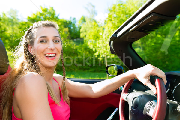 Young woman with cabriolet in summer on day trip Stock photo © Kzenon