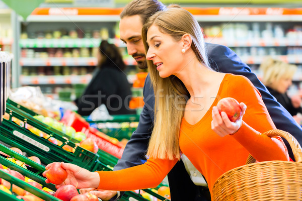 Couple selecting fruits in hypermarket Stock photo © Kzenon