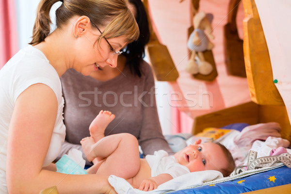 Midwife examining newborn baby Stock photo © Kzenon