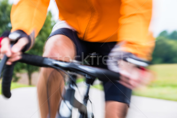 Stock photo: Fast Sport Bicyclist on bike with motion blur